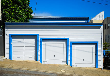 Blue and white garage doors on a streetの写真素材