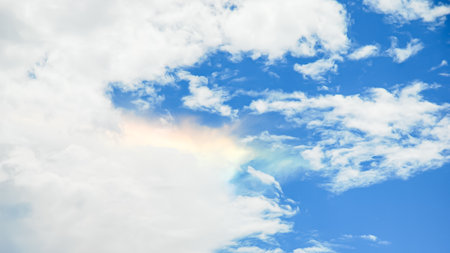 Blue sky background with white clouds and rainbow. Panoramic image.の写真素材