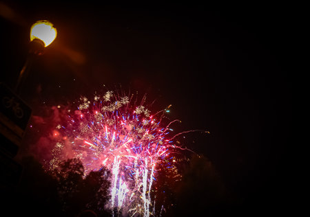 Colorful fireworks of various colors and shapes over night sky background.の写真素材