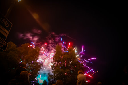 Colorful fireworks in the night sky with crowd of people on backgroundの写真素材