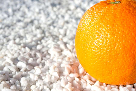 Orange on little decorative white rocksの写真素材