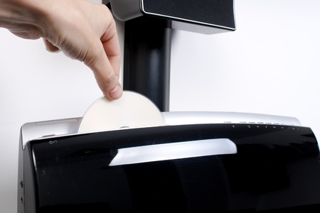 Hand inserting a DVD in a fancy player