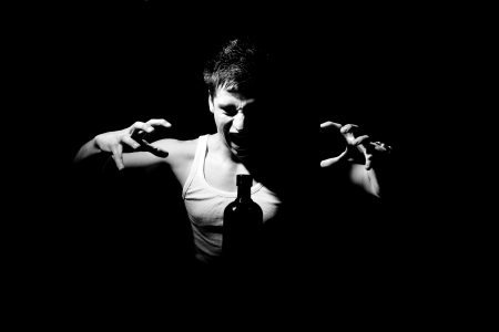 Young teenager screaming at a bottleの写真素材