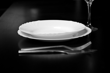 Silverware and a menu on a restaurant tableの写真素材