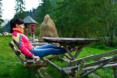 Woman sitting on a bench near the lakeの写真素材