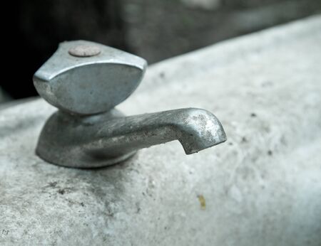 Old and dirty faucet (shallow DOF)の写真素材