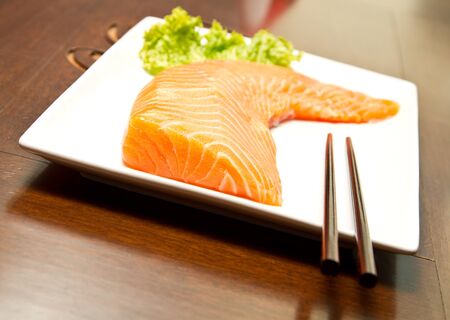 Fresh raw salmon on a plateの写真素材