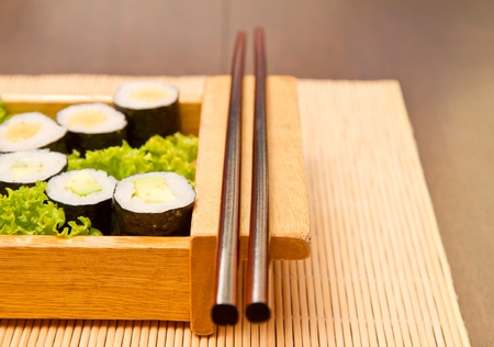 Different kinds of sushi on a wooden plateの写真素材