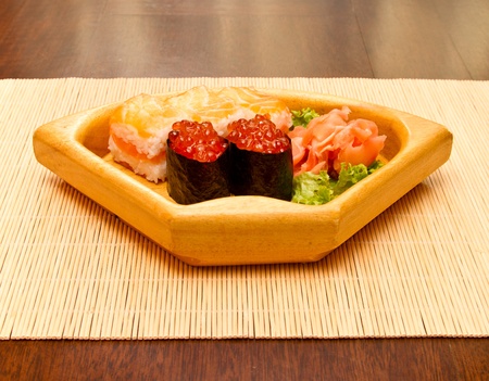 Different kinds of sushi on a wooden plateの写真素材