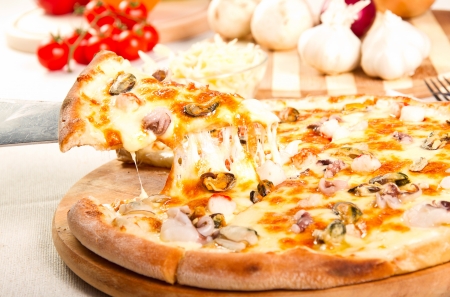 Pizza on a wooden boardの写真素材