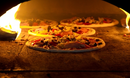 Pizza cooking in a tradition ovenの写真素材