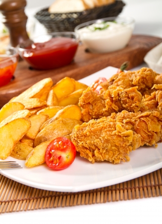 Potato wedges and fried chickenの写真素材