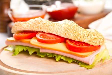 Ham and cheese sub on a wooden boardの写真素材