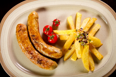 Grilled sausage with baked potatoesの写真素材