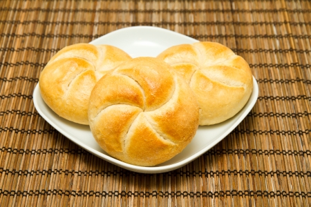 Freshly baked buns on a plateの写真素材
