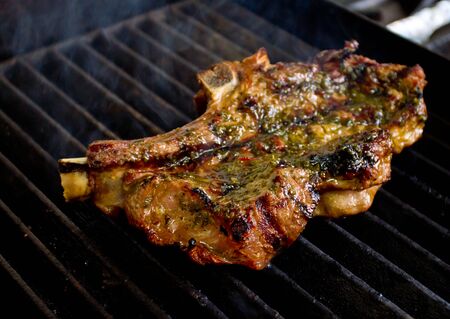 Beef steak being cooked on the barbecueの写真素材