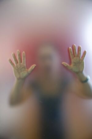 A woman pushing a glass door to open