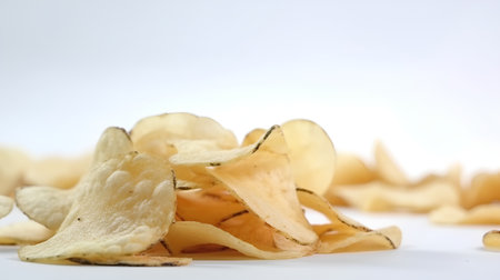 Potato chips on white background. Selective focus. Shallow depth of field.の素材