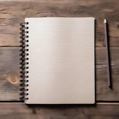 Blank paper notebook with pencil on wooden table. Top view.の素材