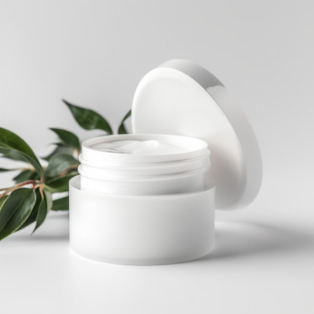 Cosmetic cream jar with green leaves on white background. 3d renderingの素材