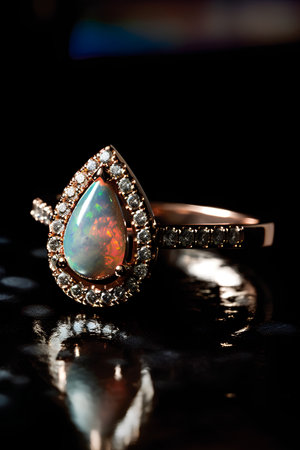 Jewelry ring with precious stones on a black background close upの素材