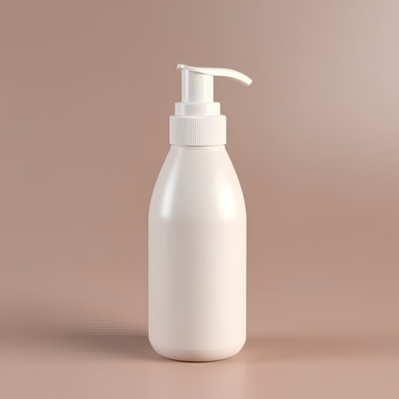 Blank white cosmetic bottle with dispenser pump on beige backgroundの素材