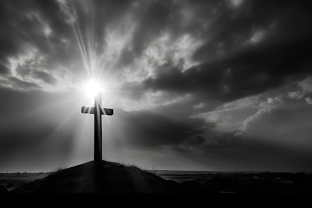 Cross on the beach with dramatic sky. Black and white image.の素材