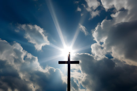 Cross on a background of the sky with clouds and rays of lightの素材