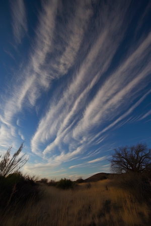 Dramatic cloud formation in the blue sky over desert landscape.の素材