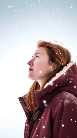 Redhead girl with winter clothes on white background with snowflakesの素材
