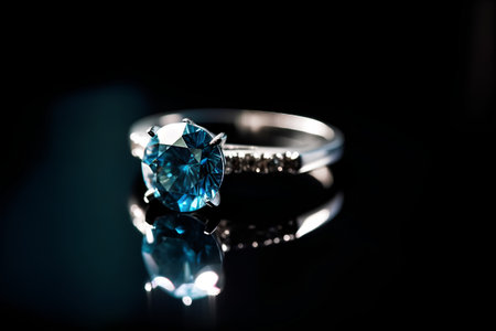 wedding ring with blue sapphire on a dark backgroundの素材