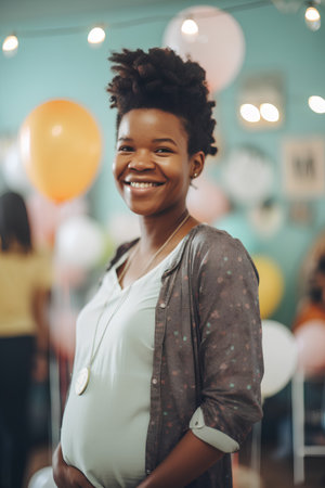 Portrait of a smiling african american pregnant woman in a studioの素材