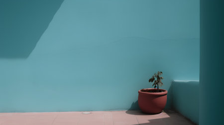 Flowerpot on a turquoise wall with shadow on itの素材
