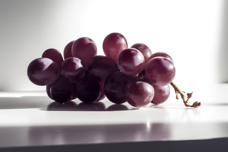 Bunch of red grapes on a white background. Toned.の素材