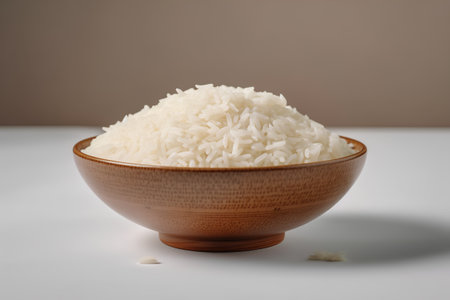 Rice in a wooden bowl on a white background. Selective focus.の素材