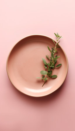 Plate with eucalyptus branch on a pink backgroundの素材