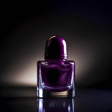 Beautiful purple nail polish bottle on dark background with copy space.の素材
