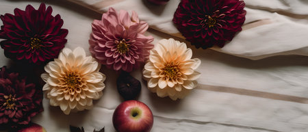 Flowers composition. Dahlias, apples and leaves on white fabric background. Flat lay, top view, copy spaceの素材