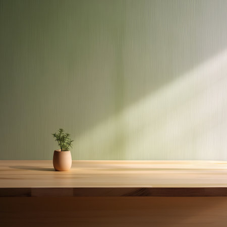 Empty wooden table with plant in vase on green wall background.の素材