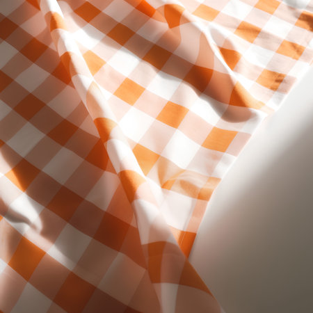 checkered tablecloth in orange and white colors, abstract backgroundの素材
