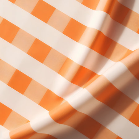 Orange and white checkered fabric as a background texture composition.の素材