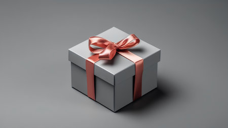 Gift box with red bow on gray background. 3d renderingの素材