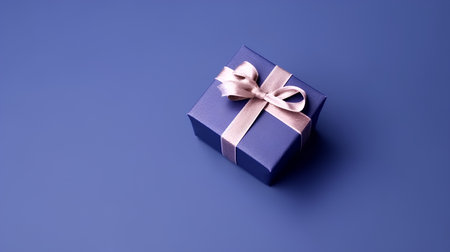 Gift box with ribbon on blue background. Flat lay, top view.の素材