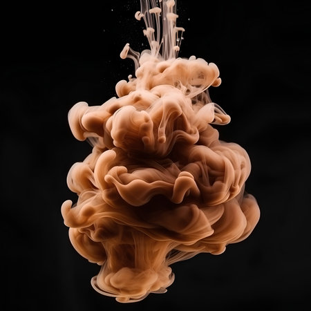 Splash of orange paint on a black background. Abstract background.の素材