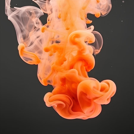Abstract orange smoke isolated on black background. Colorful ink in water.の素材