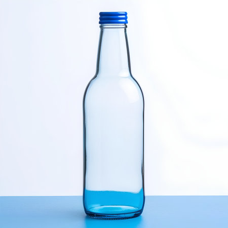 bottle of water on a blue table against a white background.の素材