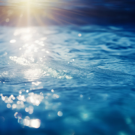 abstract background of blue water surface with sun rays and bokehの素材