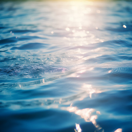 Blue sea water with sun rays and bokeh. Natural backgroundの素材