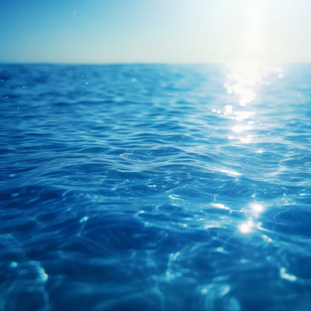 Blue sea water with sun reflections and bokeh effect, summer backgroundの素材
