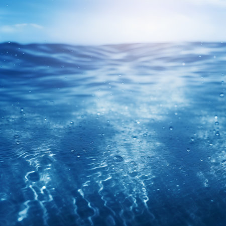 Water surface with waves and sun rays. Abstract background for design.の素材